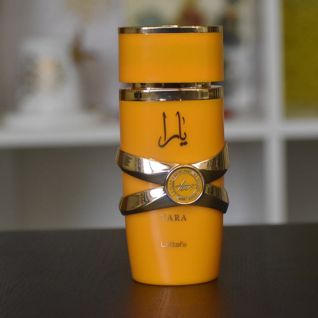 Lattafa Yara Tous EDP 100ML perfume bottle with tropical fruits and mango scent, showcasing elegant design and fragrance details.